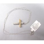Yellow and white metal crucifix pendant set with diamonds, no hallmark, on 10ct white gold chain,