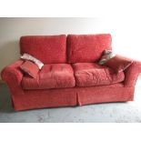 Traditional shape two seat sofa, upholstered in self patterned rust fabric, loose back and seat