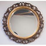 Rococo style wall mirror, circular bevelled plate in pierced scroll frame, D70cm