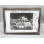 Framed and signed photo of Duncan McKenzie, jumping over a Mini at Elland Road, with another