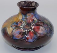 Moorcroft Pottery: Flambe Clematis pattern squat vase, tube lined with purple and red flowers on