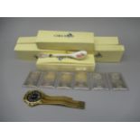 Six 999.0 fine silver one ounce ingots by Sharps Pixley and Co., a yellow metal wristwatch, and