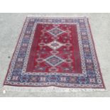 Modern Caucasian rug, triple medallion red field with in repeating striped boarder 168cm x 120cm