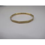 9ct yellow gold eleven sided bangle with engraved Greek Key design, stamped 9c, 17.9g