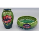 Moorcroft Pottery: Anemone pattern footed bowl, tube lined with red/purple flowers on green