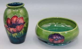 Moorcroft Pottery: Anemone pattern footed bowl, tube lined with red/purple flowers on green