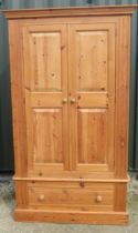 Modern pine wardrobe, moulded cornice above two twin panel doors above a drawer with turned wooden