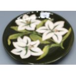 Moorcroft Pottery: Bermuda Lily pattern plate, inscribed to reverse 'The Moorcrofts sold Glendair to