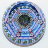 Perthshire glass paperweight, incorporating a double layer of millefiori and six latticino white and
