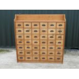 Pine bank of 42 drawers, with galleried back and painted black cast metal drawer pulls, W66cm D30cm,