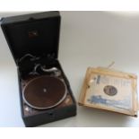 HMV table top gramophone in black carry case with a selection of records