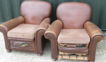 Pair of brown leather upholstered club type armchairs with sprung seats, turned wooden feet and