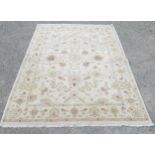 Indian pattern rug, decorated with trailing foliage on a cream ground, 240cm x 173cm