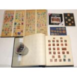 Two world stamp albums, and a collection of commemorative coins