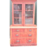 Victorian mahogany cupboard on chest, with two glazed doors above two short and two long curl veneer