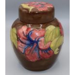 Moorcroft Pottery: Hibiscus pattern ginger jar and cover, tube lined with red and blue flowers on