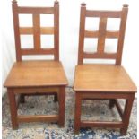 Pair of C20th oak Gothic style side chairs, with angular finials and faceted square panel back,