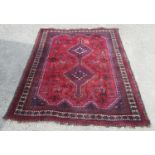 Red ground Afghan rug, the field with stepped joined medallion and geometric figures and foliage