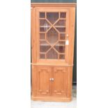 George III style pine standing corner cabinet, with moulded cornice and glazed door above a