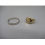 18ct white gold faceted band ring, stamped 750, size Q1/2, 2.3g, and a 9ct yellow gold signet