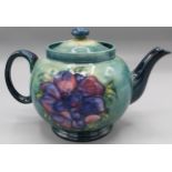 Moorcroft Pottery: Anemone pattern teapot and cover, tube lined with pink flowers on graduated green