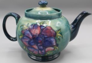 Moorcroft Pottery: Anemone pattern teapot and cover, tube lined with pink flowers on graduated green