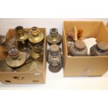 Five Aladdin paraffin lamps, two Tilley paraffin lamps and lamp parts including mantles, shades,