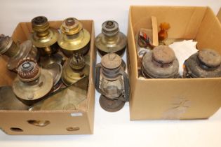 Five Aladdin paraffin lamps, two Tilley paraffin lamps and lamp parts including mantles, shades,