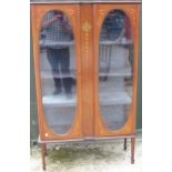 Edwardian inlaid mahogany and boxwood strung display cabinet, with two oval glazed doors and three