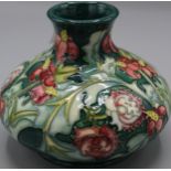 Moorcroft Pottery: Leicester pattern squat vase, tube lined with red and yellow flowers on green