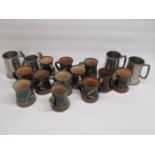 Twelve studio pottery mugs, with words to handle and 4 pewter tankards, 2 in relation to the