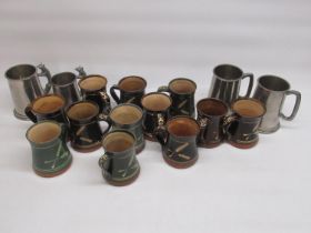 Twelve studio pottery mugs, with words to handle and 4 pewter tankards, 2 in relation to the