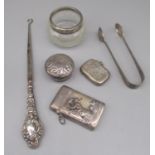 Two silver vestas, one with a mermaid design, a collection of other silver items including a