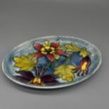 Moorcroft Pottery: Columbine pattern oval dish, tube lined with purple, red and yellow flowers on