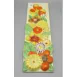 Clarice Cliff rectangular wall plaque, moulded in relief with flowers, 42.5x12cm, Clarice Cliff