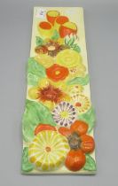 Clarice Cliff rectangular wall plaque, moulded in relief with flowers, 42.5x12cm, Clarice Cliff