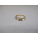 18ct yellow gold ring set with central square cut diamond, and diamond set edges, stamped K18,