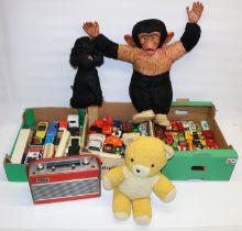Three boxes of die-cast model vehicles, incl. Matchbox; three mid C20th soft toys incl. a monkey;