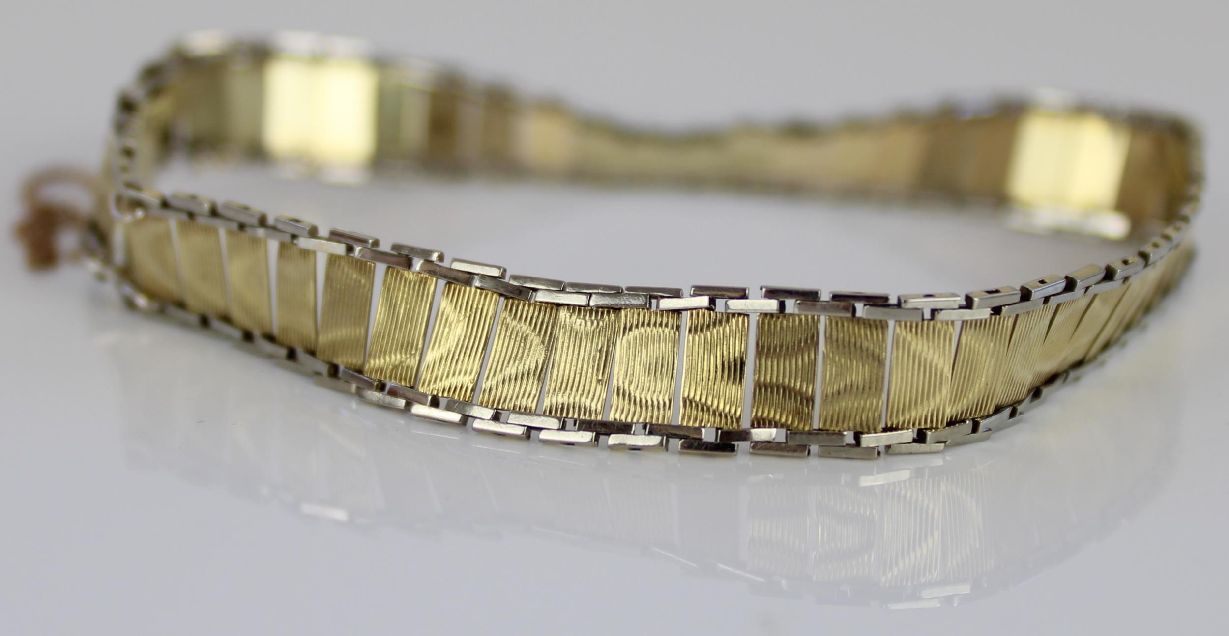 14ct yellow and white gold articulated bracelet with box clasp and safety chain, stamped 585, 8.6g