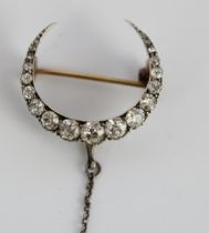 Victorian yellow and white metal crescent brooch set with graduated round cut diamonds in claw