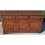 C18th style oak dresser, moulded top above three fielded panel drawers and three similar doors, on