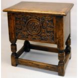 C17th style oak box stool, front carved with a Yorkshire Rose and leafage, with hinged top on turned