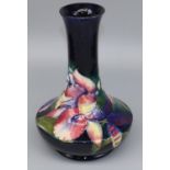 Moorcroft Pottery: Orchid pattern vase, compressed form with waisted neck, tubelined decoration of