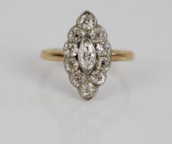 Yellow metal diamond ring, the central marquise cut diamond surrounded by a halo of round cut