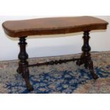Victorian walnut centre table, figured shaped oval top with carved border, on carved baluster