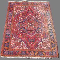 Persian multicoloured rug, with floral medalion field with geometric spandrels in repeating
