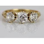 18ct yellow gold three stone diamond ring, the central round cut diamond flanked by two smaller
