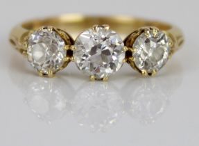 18ct yellow gold three stone diamond ring, the central round cut diamond flanked by two smaller