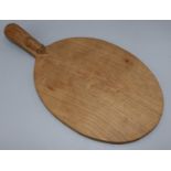 Robert Mouseman Thompson of Kilburn - an adzed oak oval cheese board, curved handle carved with
