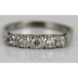 White metal five stone diamond ring, the round cut diamonds in rub-over settings, on plain shank, no